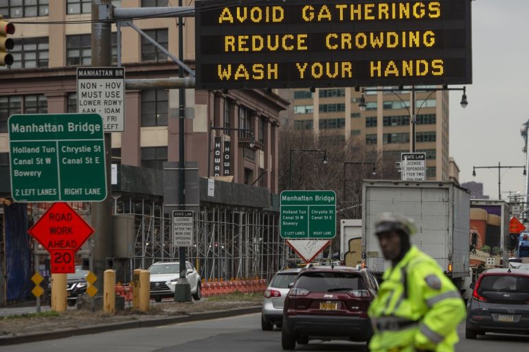 NEW YORK, NY - MARCH 19: A sign warns residents to take steps to contol the outbreak at the entrance to the Manhattan Bridge in Brooklyn as the Coronavirus, COVID19, outbreak continued unabated on March 19, 2020 in New York City. The economic situation in the city continued to decline as more businesses closed their doors and New York weighed a shelter in place order for the entire city. Victor J. Blue/Getty Images/AFP== FOR NEWSPAPERS, INTERNET, TELCOS & TELEVISION USE ONLY ==