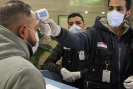 Egyptian Quarantine Authority employees scan body temperature for incoming travellers at Cairo International Airport on Feb 1, 2020.PHOTO- AFP copy.jpg