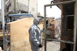 Precautions taken for coronavirus in Baghdad- - BAGHDAD, IRAQ - MARCH 09: Civil defense team with protective suits disinfect the streets and workplaces as a precaution to the coronavirus (Covid-19) in Baghdad, Iraq on March 09, 2020.