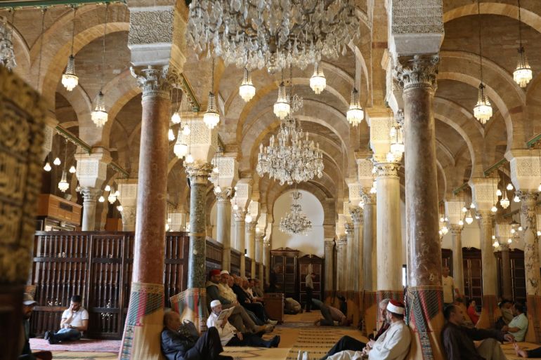 Men read the Koran at a mosque on the first day of Ramadan in Tunis, Tunisia, May 17, 2018. REUTERS/Zoubeir Souissi