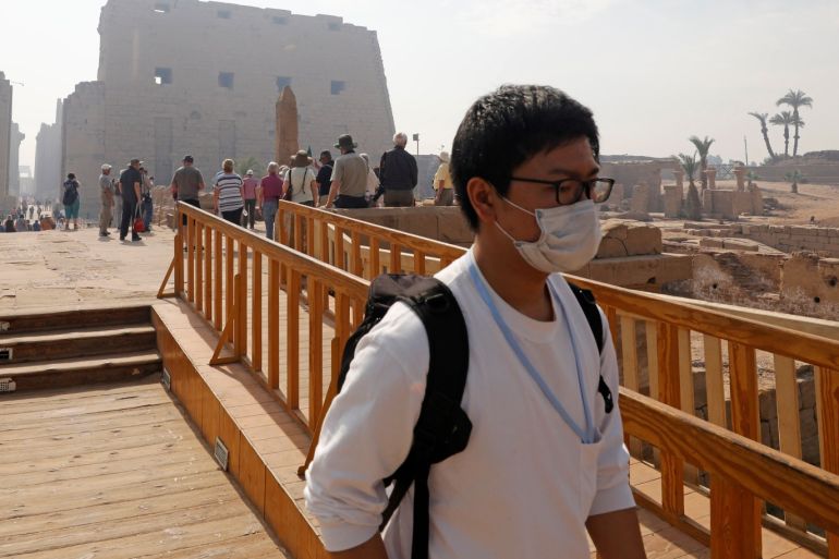 A tourist wears a protective mask, following an outbreak of the coronavirus (COVID-19), during his visit to Luxor Temple in Egypt March 9, 2020. REUTERS/Mohamed Abd El Ghany