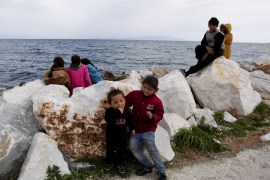 MYTHILINI, GREECE - MARCH 07: Asylum seeker children sit near the port of Mytilene on the island of Lesbos on March 7, 2020 in Mytilene, Greece. A warship is hosting some of 500 migrants who arrived from Turkey to the island of Lesbos in the last few days. Thousands of refugees and migrants have flocked to the Greece, Turkey border after Turkey announced that it would open border gates for a period of 72hrs to allow refugees to cross into European countries after thirty three Turkish soldiers were killed in a Syrian air raid in Idlib. (Photo by Milos Bicanski/Getty Images)