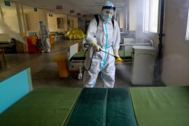 A worker in protective suit disinfects the Wuhan No. 7 Hospital, once a designated hospital for coronavirus disease (COVID-19) patients, to prepare it for the resumption of its normal service in Wuhan, Hubei province, China March 19, 2020. cnsphoto via REUTERS ATTENTION EDITORS - THIS IMAGE WAS PROVIDED BY A THIRD PARTY. CHINA OUT.
