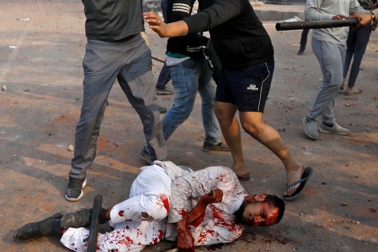 SENSITIVE MATERIAL. THIS IMAGE MAY OFFEND OR DISTURB People supporting a new citizenship law beat a Muslim man during a clash with those opposing the law in New Delhi, India, February 24, 2020. Picture taken February 24, 2020. REUTERS/Danish Siddiqui