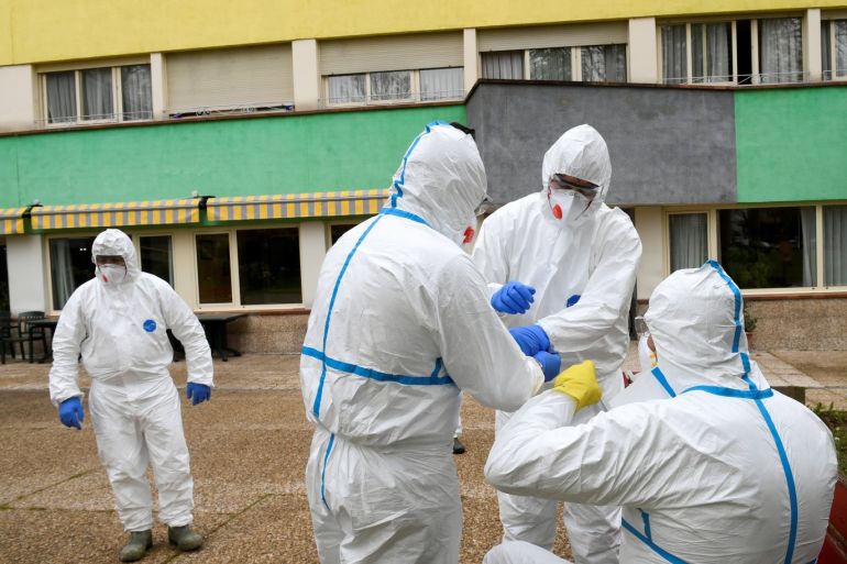 Sanitary workers prepare to clean the nursing home where a woman died and several residents and care providers have been diagnosed with coronavirus disease (COVID-19) in Grado, Asturias, Spain March 20, 2020. REUTERS/Eloy Alonso