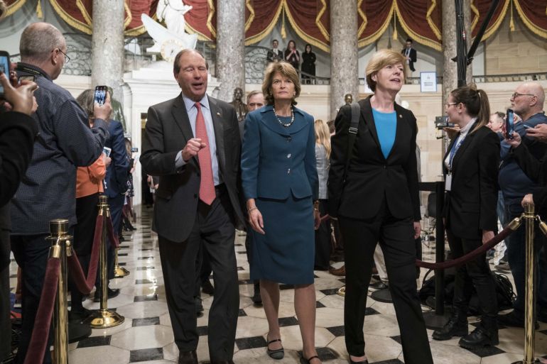 WASHINGTON, DC - FEBRUARY 04: Sen. Tom Udall (D-NM), Sen. Lisa Murkowski (R-AK) and Sen. Tammy Baldwin (D-WI) walk through Statuary Hall to the House Chamber for the State of the Union on February 4, 2020 in Washington, DC. President Trump delivers his third State of the Union to the nation the night before the U.S. Senate is set to vote in his impeachment trial. Sarah Silbiger/Getty Images/AFP== FOR NEWSPAPERS, INTERNET, TELCOS & TELEVISION USE ONLY ==
