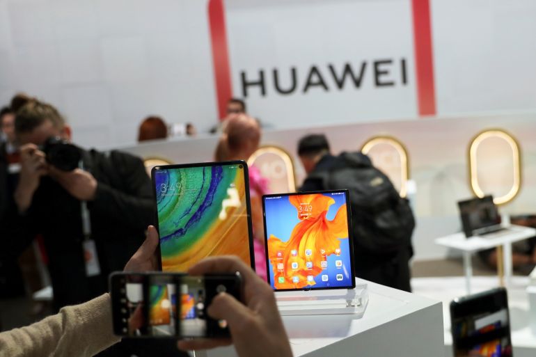 People take pictures of Huawei Mate Xs foldable smartphone and a Huawei MatePad Pro during Huawei product launch event in Barcelona, Spain February 24, 2020. REUTERS/Nacho Doce