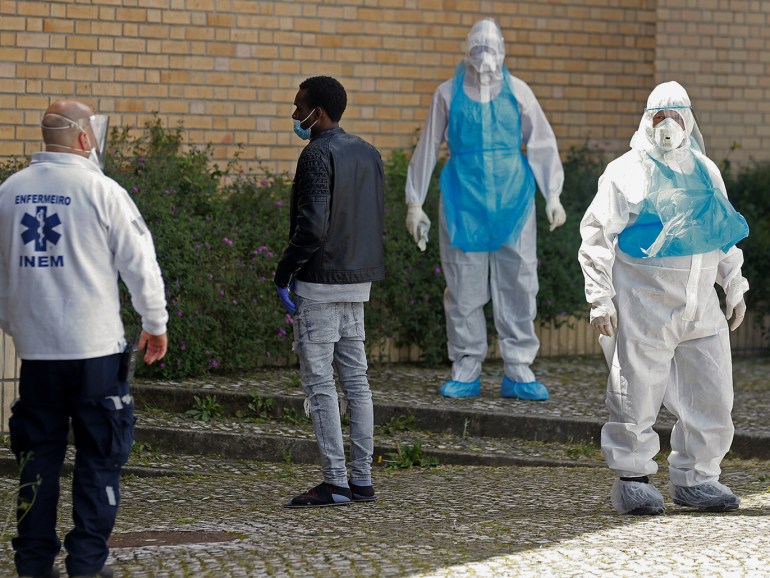 Medical staff members stand next to asylum seekers, as 170 of them, evacuated from a hostel, arrive to the central mosque to be tested, during the outbreak of the coronavirus disease (COVID-19), in Lisbon, Portugal April 19, 2020. REUTERS/Rafael Marchante