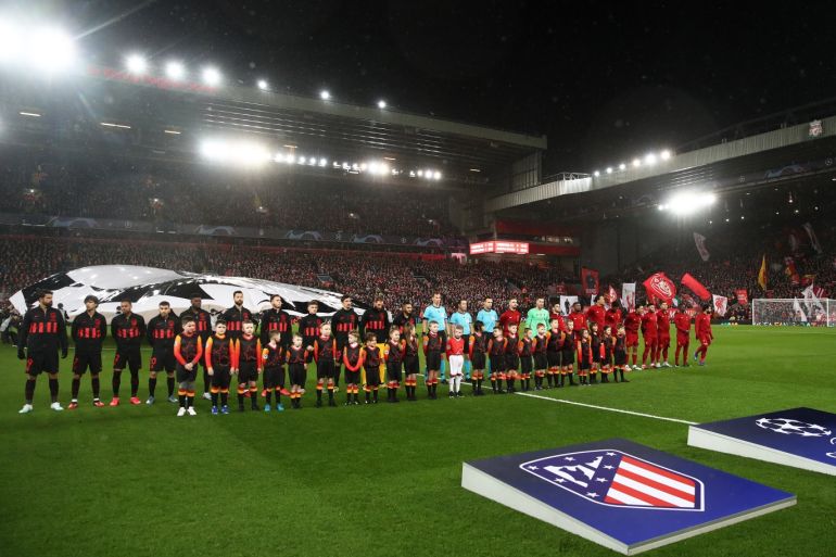 LIVERPOOL, ENGLAND - MARCH 11: The two teams line up before the UEFA Champions League round of 16 second leg match between Liverpool FC and Atletico Madrid at Anfield on March 11, 2020 in Liverpool, United Kingdom. (Photo by Julian Finney/Getty Images)