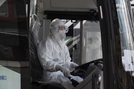 BEIJING, CHINA - APRIL 08: A Chinese bus driver wears a protective white suit as he waits to drive travellers from Wuhan as they are processed and taken to do 14 days of quarantine, after arriving on the first trains to Beijing on April 8, 2020 in Beijing, China. China lifted its lockdown on Wuhan, the first epicentre of COVID-19 after 76 days, allowing healthy people to leave. China recorded for the first time since January 21st no coronavirus-related deaths. With the pandemic hitting hard across the world, officially the number of coronavirus cases in China is dwindling, ever since the government imposed sweeping measures to keep the disease from spreading. For more than two months, millions of people across China have been restricted in how they move from their homes, while other cities have been locked down in ways that appeared severe at the time but are now being replicated in other countries trying to contain the virus. Officials believe the worst appears to be over in China, though there are concerns of another wave of infections as the government attempts to reboot the worlds second largest economy. In Beijing, it is mandatory to wear masks outdoors, some retail stores still operate on reduced hours, restaurants employ social distancing among patrons, and tourist attractions at risk of drawing large crowds remain closed or allow only limited access. Monitoring and enforcement of virus-related measures and the quarantine of anyone arriving to Beijing is carried out by neighborhood committees and a network of Communist Party volunteers who wear red arm bands. Since January, China has recorded more than 81,000 cases of COVID-19 and at least 3200 deaths, mostly in and around the city of Wuhan, in central Hubei province, where the outbreak first started. (Photo by Kevin Frayer/Getty Images)