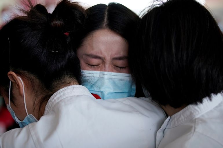 Medical workers hug at the Wuhan Tianhe International Airport after travel restrictions to leave Wuhan, the capital of Hubei province and China's epicentre of the novel coronavirus disease (COVID-19) outbreak, were lifted, April 8, 2020. REUTERS/Aly Song TPX IMAGES OF THE DAY