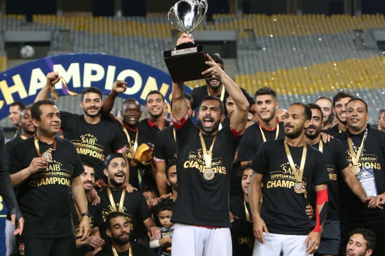 Soccer Football - Egyptian Super Cup - Al Ahly v Zamalek - Borg El Arab Stadium, Alexandria, Egypt - September 20, 2019 Al Ahly's Ahmed Fathi and team mates celebrate winning the Egyptian Super Cup with the trophy REUTERS/Mohamed Abd El Ghany