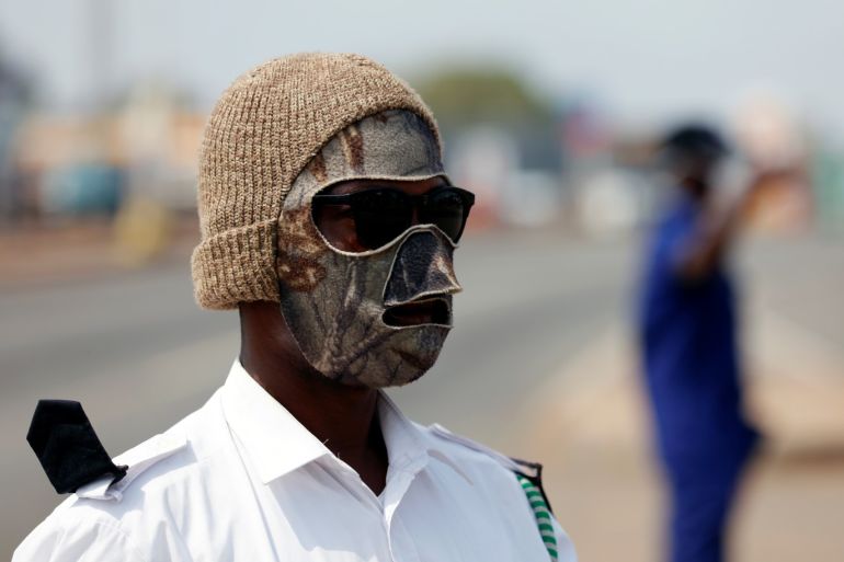 A security personnel from town council wearing a face mask controls trafic, as Ghana enforces partial lockdown in the cities of Accra and Kumasi to slow the spread of the coronavirus disease (COVID-19) in Madina neighborhood of Accra, Ghana, March 31, 2020. REUTERS/Francis Kokoroko