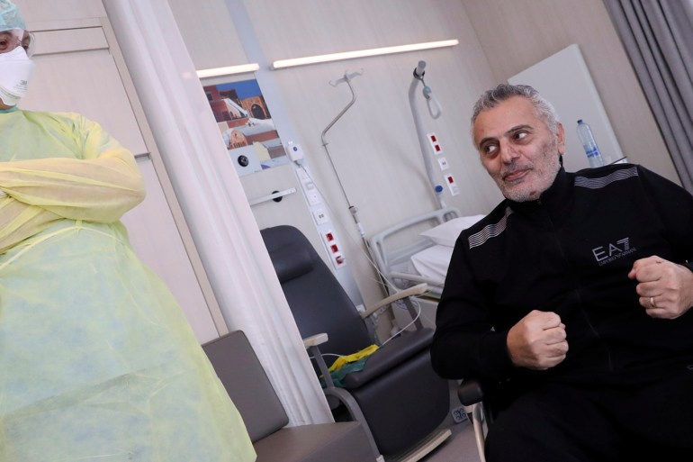 Belgian doctor Antoine Sassine, a urologist at Chirec Delta Hospital, who survived the coronavirus disease (COVID-19) after spending 6 weeks in the intensive care unit, among it 3.5 weeks in a coma, reacts with anesthesist doctor Mathieu Clanet who took care of him and head of the intensive care Sophie Cran at Chirec Delta Hospital in Brussels, Belgium, April 18, 2020. Picture taken April 18, 2020. REUTERS/Yves Herman