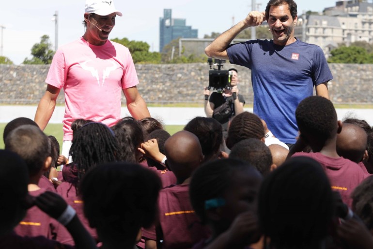 Roger Federer and Rafael Nadal in charity exhibition in Cape Town - - CAPE TOWN, SOUTH AFRICA - FEBRUARY 8 : Roger Federer (R) of Switzerland and Rafael Nadal (L) of Spain gather with children at Roger Federer Foundation ahead of attending a tennis match at Grand Parade as part of an exhibition game held to support the education of African children, on February 8, 2020 in Cape Town, South Africa.