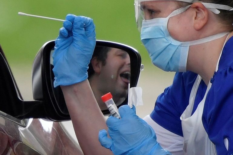 Medical staff are seen testing people at a coronavirus test centre in the car park of Chessington World of Adventures as the spread of the coronavirus disease (COVID-19) continues, Chessington, Britain, April 2, 2020. REUTERS/Toby Melville TPX IMAGES OF THE DAY