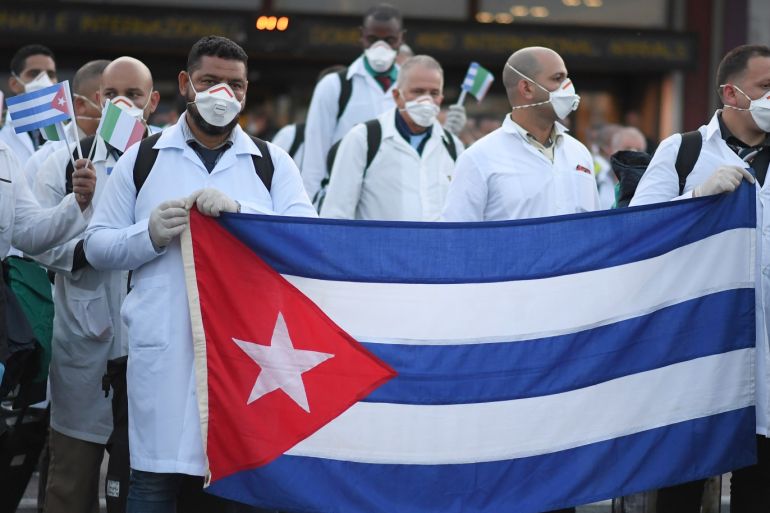 An emergency contingent of Cuban doctors and nurses arrive at Italy's Malpensa airport after travelling from Cuba to help Italy battle the spread of coronavirus disease (COVID-19), near Milan, Italy, March 22, 2020. REUTERS/Daniele Mascolo