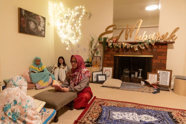 MELBOURNE, AUSTRALIA - MAY 22: Dewi Andrina reads the Quran with her daughters following prayers on May 22, 2020 in Melbourne, Australia. Muslim communities across Australia are finding ways to celebrate Eid al-Fitr marking the end of Ramadan, in smaller groups due to restrictions on gathering sizes due to COVID-19. Many mosques remain closed with some providing limited access and streaming prayer services. (Photo by Asanka Ratnayake/Getty Images)