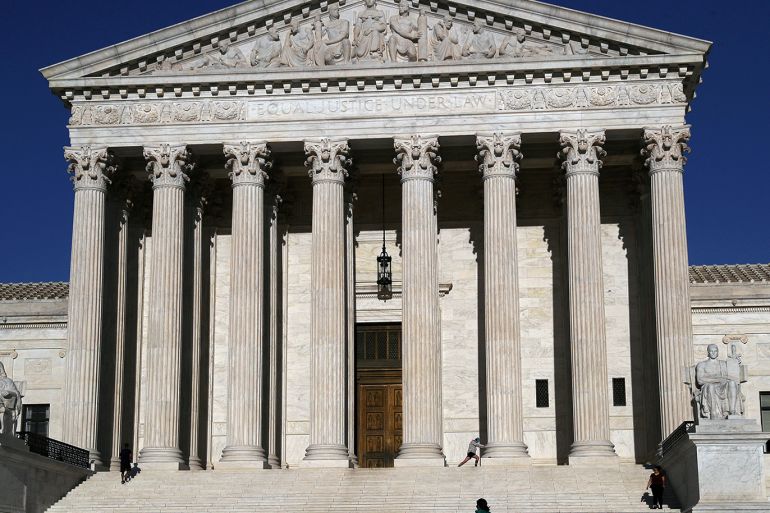 FILE PHOTO: People work out on the steps of the U.S. Supreme Court as the spread of coronavirus disease (COVID-19) continues in Washington, U.S., April 6, 2020. REUTERS/Leah Millis/File Photo