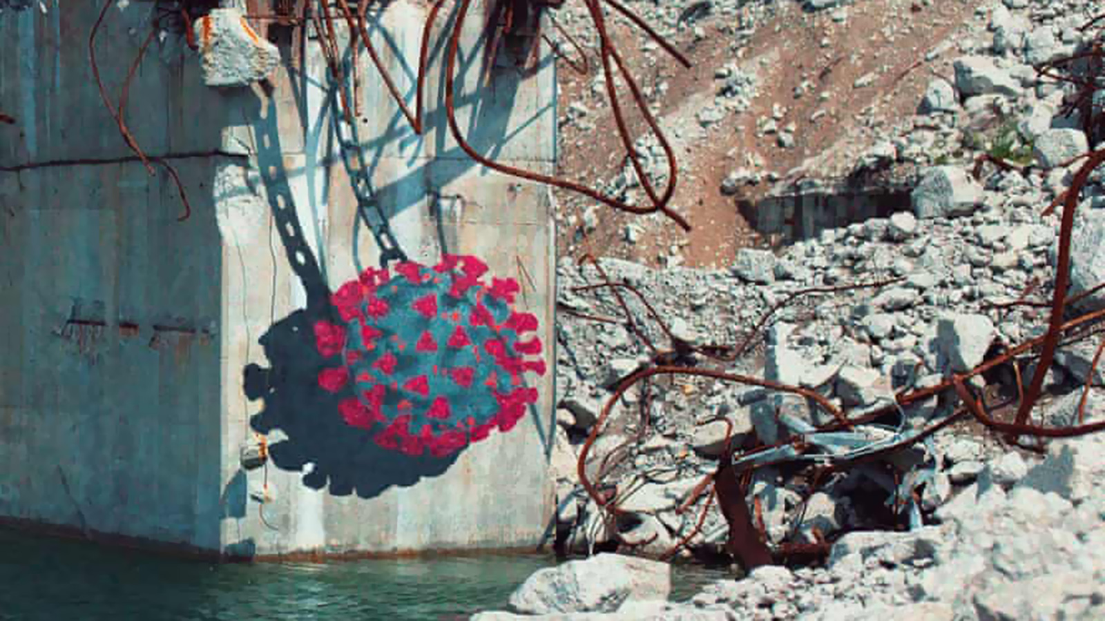 ‪الفنان شون يورو اختار موقعا متهدما من شاطئ ورسم على أحد الأعمدة الخرسانية الموجودة فيه خلية فيروس كورونا‬ (مواقع التواصل الاجتماعي)