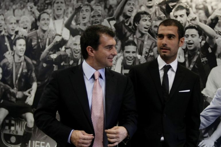 Barcelona FC's President Joan Laporta (L) and newly-signed coach Pep Guardiola arrive at a news conference in front of a UEFA Champions trophy 2006 picture before Guardiola's official presentation at Nou Camp stadium in Barcelona June 17, 2008. REUTERS/Gustau Nacarino (SPAIN)