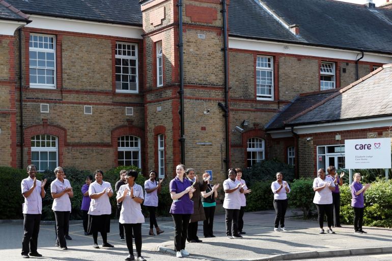 Care workers at the Elizabeth Lodge Care Home join members of the public in a weekly clap in support of care workers, during the coronavirus disease (COVID-19) pandemic, in Enfield, Britain, April 27, 2020. Picture taken April 27, 2020. To match Special Report HEALTH-CORONAVIRUS/BRITAIN-ELDERLY REUTERS/Peter Nicholls