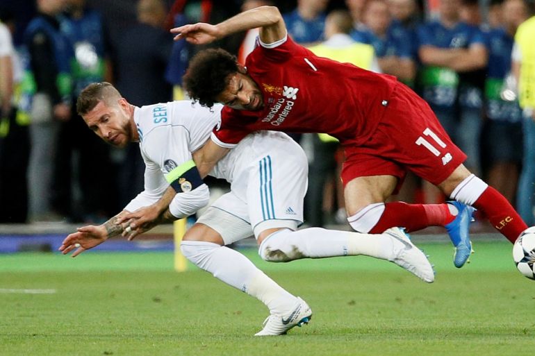 Soccer Football - Champions League Final - Real Madrid v Liverpool - NSC Olympic Stadium, Kiev, Ukraine - May 26, 2018 Liverpool's Mohamed Salah injures his shoulder in a challenge with Real Madrid's Sergio Ramos REUTERS/Gleb Garanich