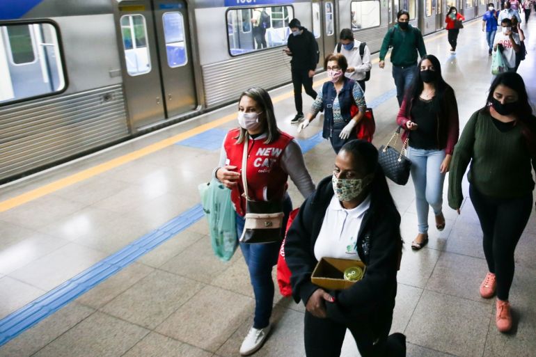 SAO PAULO, BRAZIL - MAY 04: Passengers wearing face masks leave a subway car amidst the coronavirus (COVID-19) pandemic on May 4, 2020 in Sao Paulo, Brazil. The use of protective masks against the coronavirus (COVID-19) becomes mandatory in the public transport of Sao Paulo State. The measure applies to the subway, trains, and buses. According to the Brazilian Health Ministry, Brazil has 105.222 positive cases of coronavirus (COVID-19) and a total of 7.288 deaths. (Photo by Alexandre Schneider/Getty Images)