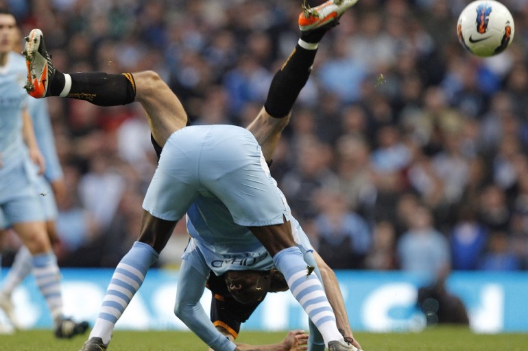 Manchester City's Mario Balotelli (front) challenges Wolverhampton Wanderers' Roger Johnson during their English Premier League soccer match at the Etihad Stadium in Manchester, northern England, October 29, 2011. REUTERS/Phil Noble (BRITAIN - Tags: SPORT SOCCER TPX IMAGES OF THE DAY) FOR EDITORIAL USE ONLY. NOT FOR SALE FOR MARKETING OR ADVERTISING CAMPAIGNS. NO USE WITH UNAUTHORIZED AUDIO, VIDEO, DATA, FIXTURE LISTS, CLUB/LEAGUE LOGOS OR