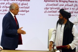 Mullah Abdul Ghani Baradar, the leader of the Taliban delegation, and Zalmay Khalilzad, U.S. envoy for peace in Afghanistan, are seen after signing an agreement at a signing ceremony between members of Afghanistan's Taliban and the U.S. in Doha, Qatar February 29, 2020. REUTERS/Ibraheem al Omari