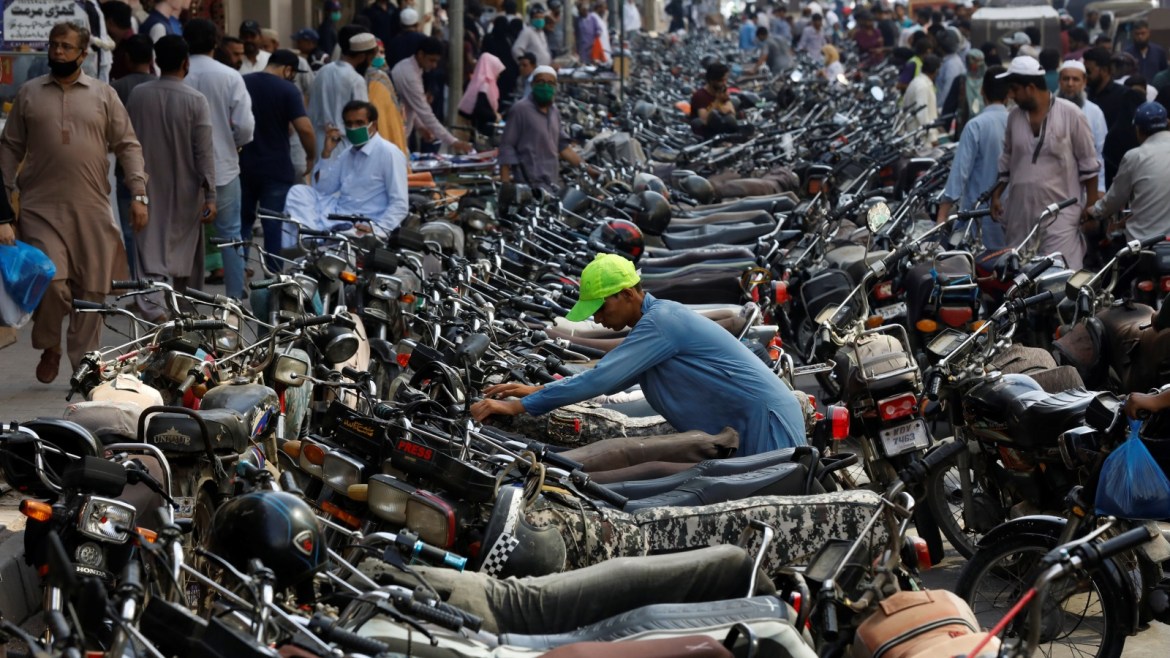 A boy parks his motorcycle amid hundreds of others outside a shopping bazar, after Pakistan started easing the lockdown as the spread of the coronavirus disease (COVID-19) continues, in Karachi, Pakistan May 12, 2020. REUTERS/Akhtar Soomro
