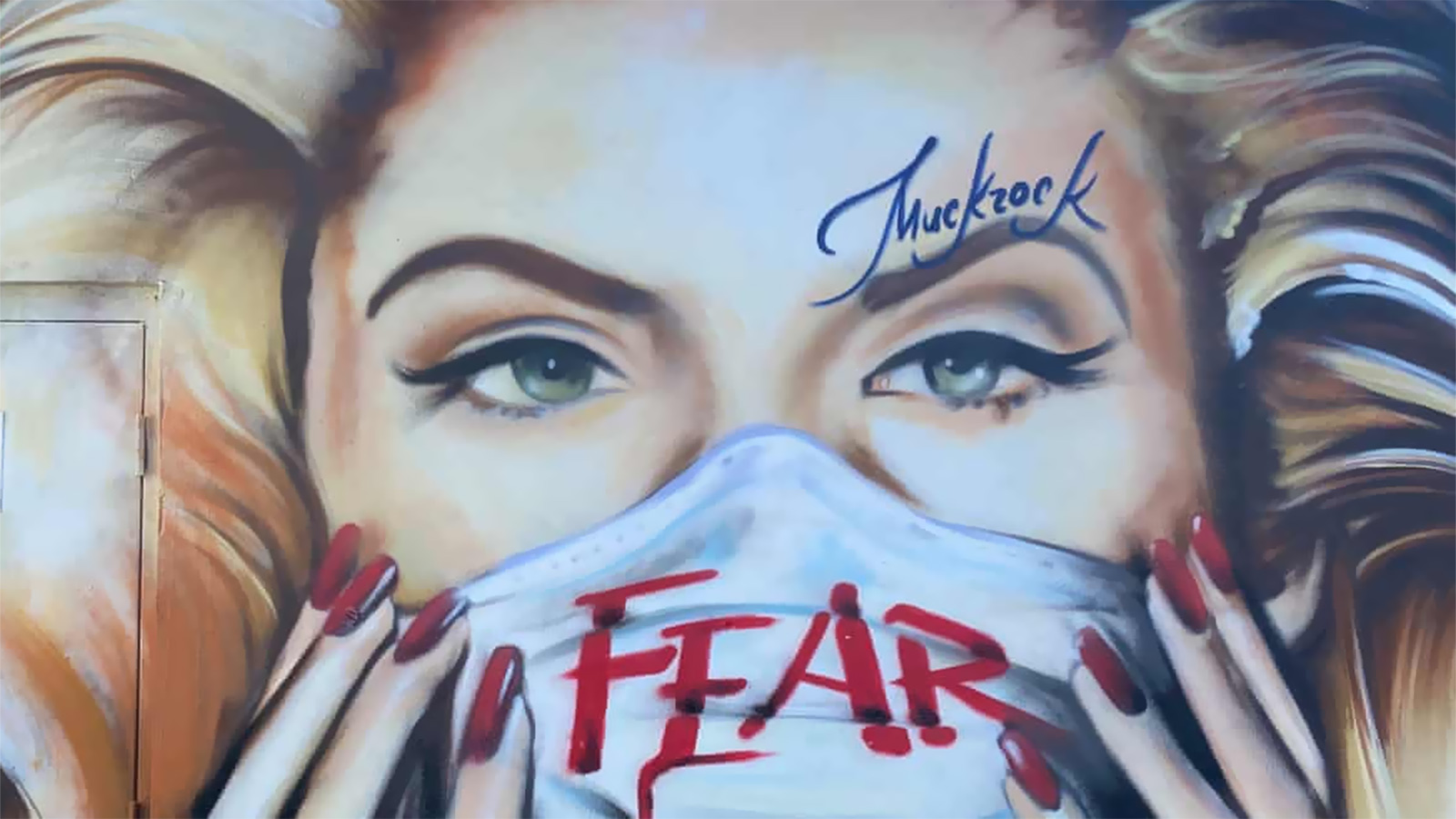 ‪موك روك رسم لوحة جدارية كبيرة لآنا نيكول سميث وهي ترتدي قناع وجه كتبت عليه كلمة 