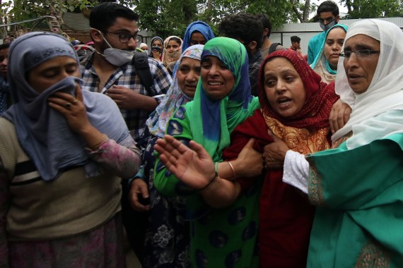 Indian soldiers shot dead a civilian in Kashmir- - BUDGAM, KASHMIR, INDIA-MAY 13: Sister (c) mourns the death of her brother Mehraj-u-din Shah, who was killed by Indian soldiers near a check point at Kawoosa,Narbal in central Kashmir's Budgam on May 13, 2020.Police said that a civilian travelling in a car jumped at two check points after which Indian paramilitary soldiers fired at him in which he got injured ,he was shifted to the hospital where doctors declared him dead on arrival. However victim’s father denied the police version, saying his son did not drive through any check points and soldiers stopped him and then shot him, he said to a news agency.