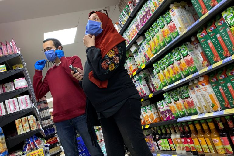 A family with protective masks is seen at a market in Cairo