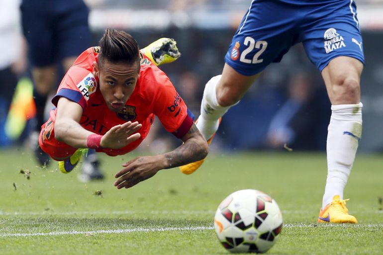 Barcelona's Neymar is tackled by Espanyol's Lucas Vazquez during their Spanish first division soccer match near Barcelona