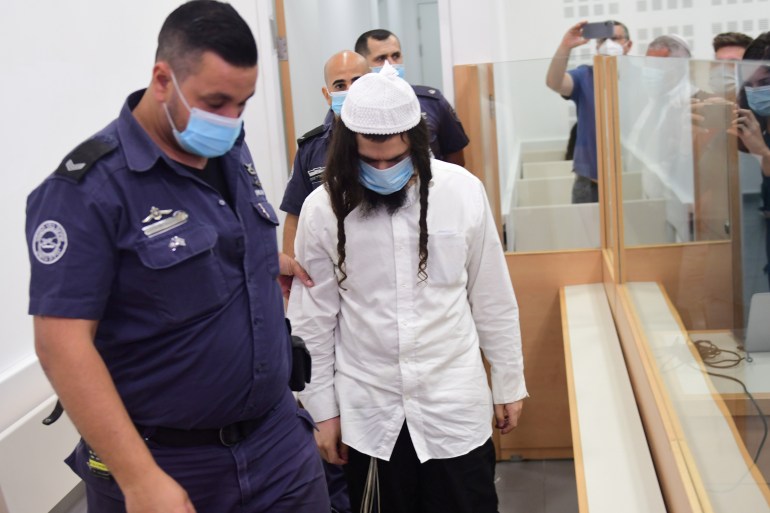 Amiram Ben-Uliel is brought for a verdict in the case of the 2015 arson attack, which killed a Palestinian toddler and his parents in the Israeli-occupied West Bank village of Duma, at the Central Lod District Court in Lod
