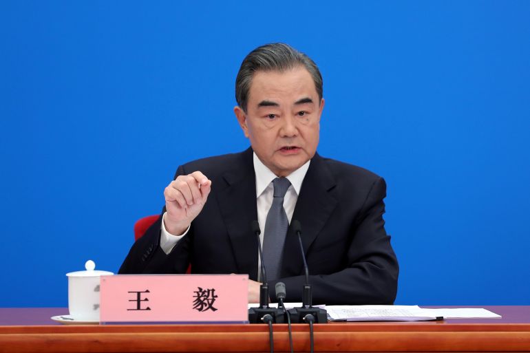 Chinese State Councillor and Foreign Minister Wang Yi speaks to reporters via video link at a news conference held on the sidelines of NPC in Beijing