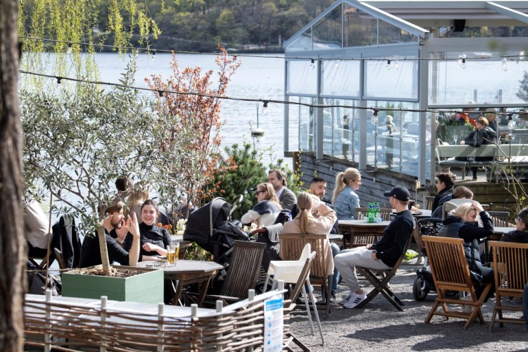 People enjoy the spring weather at an outdoor restaurant amid the outbreak of the coronavirus disease (COVID-19), in Stockholm, Sweden April 26, 2020. Jessica Gow/TT News Agency/via REUTERS ATTENTION EDITORS - THIS IMAGE WAS PROVIDED BY A THIRD PARTY. SWEDEN OUT. NO COMMERCIAL OR EDITORIAL SALES IN SWEDEN.