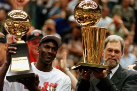 Chicago Bulls Michael Jordan (L) and coach Phil Jackson holds their MVP and NBA championship trophies, respectively, after the Bulls defeated the Jazz 87-86 to win the NBA championship June 14th. The Bulls won their sixth title and third in a row.SSM/RC/SB