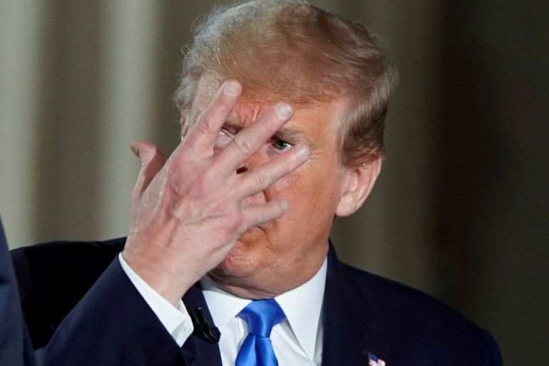 U.S. President Donald Trump gestures as he consults with White House Chief of Staff Mark Meadows during a commercial break as the president participates in a live Fox News Channel virtual town hall called