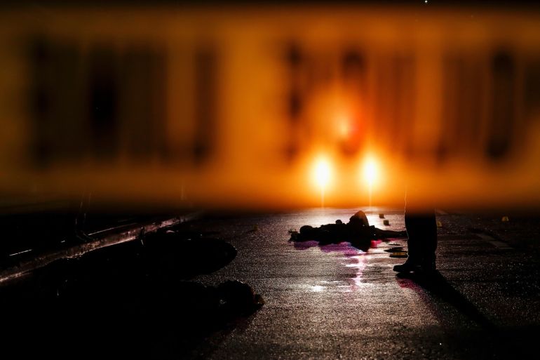 Bodies of two men are lit by a police car in Manila, Philippines early October 29, 2016. According to the police, guns and sachet containing what is believed to be drug shabu (Metamphetamine Hydrochloride) were found with two men who were shot dead after trying to speed away from a police checkpoint. Picture taken October 29, 2016. REUTERS/Damir Sagolj TPX IMAGES OF THE DAY