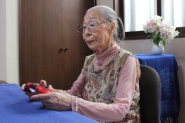 This handout photo taken on May 29, 2020 and received on May 31 courtesy of Keisuke Nagao shows 90-Year-old Hamako Mori, dubbed Japan's "Gamer Grandma", holding a video game controller in Matsudo, Chiba prefecture. - The pensioner known as "Gamer Grandma" spends three or more hours a day battling monsters and going on missions in the virtual worlds of her favourite games, and even has a popular YouTube channel for her fans. (Photo by Handout / Courtesy of Keisuke Nagao / AFP) / RESTRICTED TO EDITORIAL USE - MANDATORY CREDIT "AFP PHOTO / Courtesy of Keisuke Nagao" - NO MARKETING NO ADVERTISING CAMPAIGNS - DISTRIBUTED AS A SERVICE TO CLIENTS --- NO ARCHIVES --- To go with interview by Shingo ITO