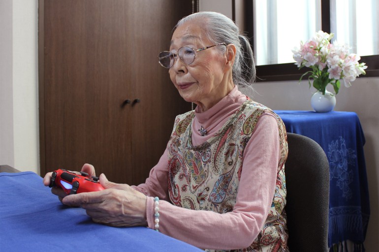 This handout photo taken on May 29, 2020 and received on May 31 courtesy of Keisuke Nagao shows 90-Year-old Hamako Mori, dubbed Japan's "Gamer Grandma", holding a video game controller in Matsudo, Chiba prefecture. - The pensioner known as "Gamer Grandma" spends three or more hours a day battling monsters and going on missions in the virtual worlds of her favourite games, and even has a popular YouTube channel for her fans. (Photo by Handout / Courtesy of Keisuke Nagao / AFP) / RESTRICTED TO EDITORIAL USE - MANDATORY CREDIT "AFP PHOTO / Courtesy of Keisuke Nagao" - NO MARKETING NO ADVERTISING CAMPAIGNS - DISTRIBUTED AS A SERVICE TO CLIENTS --- NO ARCHIVES --- To go with interview by Shingo ITO