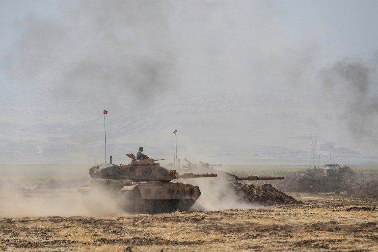 (FILES) In this file photo taken on September 27, 2017 Turkish troops man tanks during military exercises near the Habur crossing gate between Turkey and Iraq in the Silopi district, southeast Turkey. - Turkey launched an air and ground offensive against Kurdish rebels in northern Iraq on June 17, 2020 in a move likely to increase friction with the Baghdad government. The defence ministry said "commandos" moved in supported by drones and helicopters, following a bombardment with rocket launchers and artillery guns that hit more than 150 targets. (Photo by ILYAS AKENGIN / AFP)
