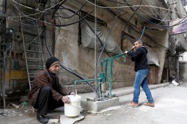 Hisham al-Zarqawi uses a hand-pump to collect water in Ein Terma, a district of eastern Ghouta, Syria February 26, 2019. Picture taken February 26, 2019. REUTERS/Omar Sanadiki