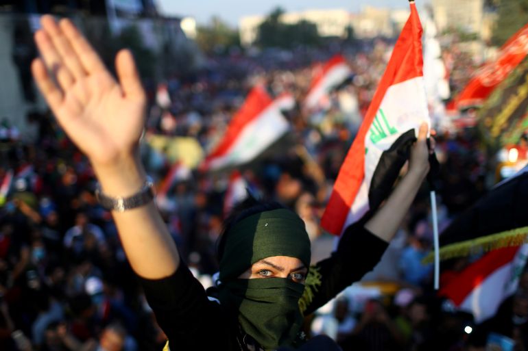 An Iraqi female demonstrator attends the ongoing anti-government protests in Baghdad