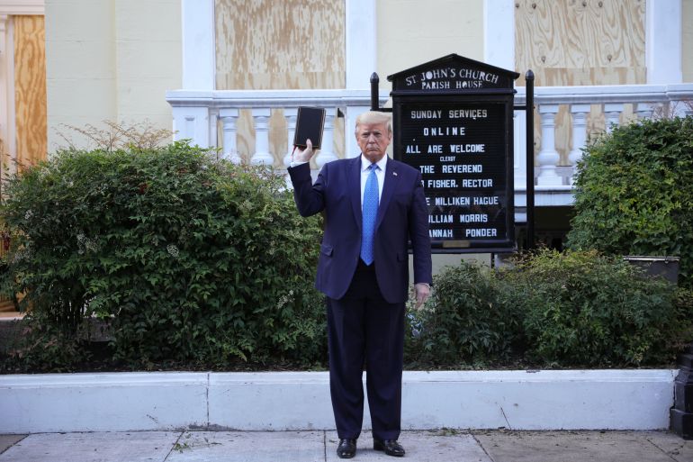 U.S. President Trump holds up Bible during photo opportunity in front of St John's Church in Washington