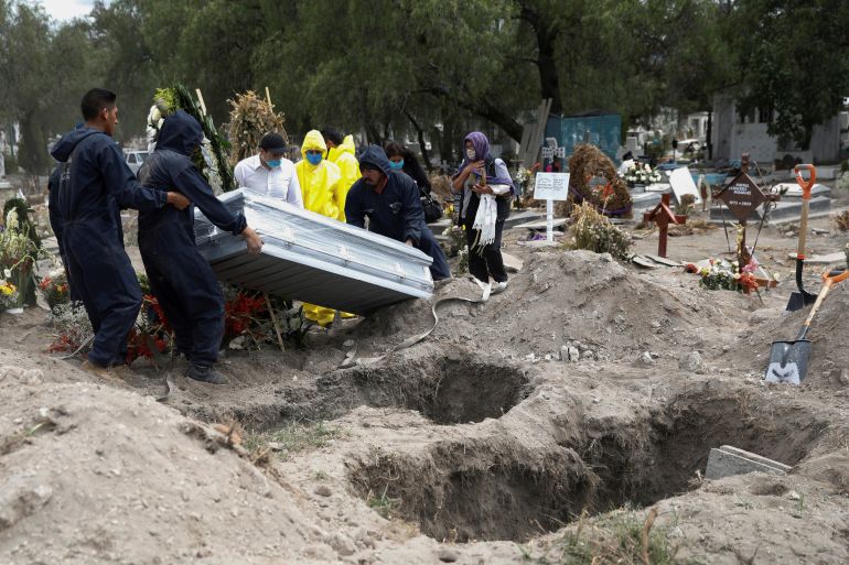 Cemetery workers and family members carry a coffin containing the body of a person who died of the coronavirus disease (COVID-19) in Mexico City