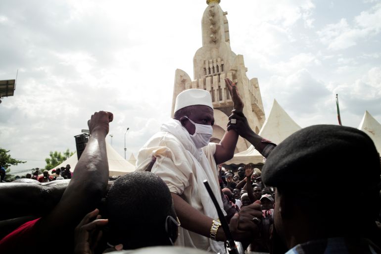 Imam Mahmoud Dicko wears a protective mask as he arrives to address his supporters as they hold a mass protest demanding the resignation of Mali's President Ibrahim Boubacar Keita at the Independence Square in Bamako, Mali June 5, 2020. REUTERS/Matthieu Rosier