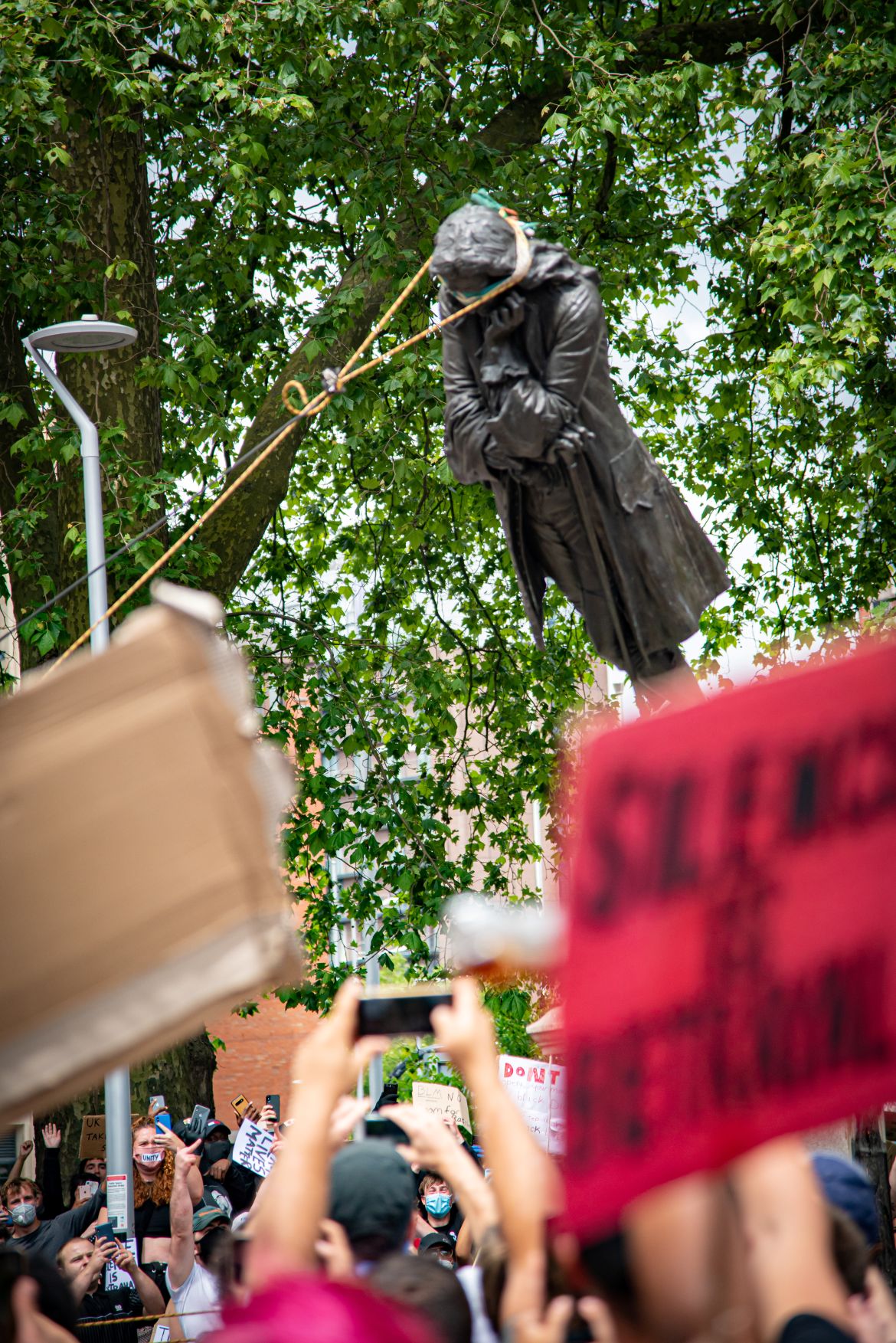 The statue of Edward Colston falls down as protesters pull it down, following the death of George Floyd who died in police custody in Minneapolis, in Bristol